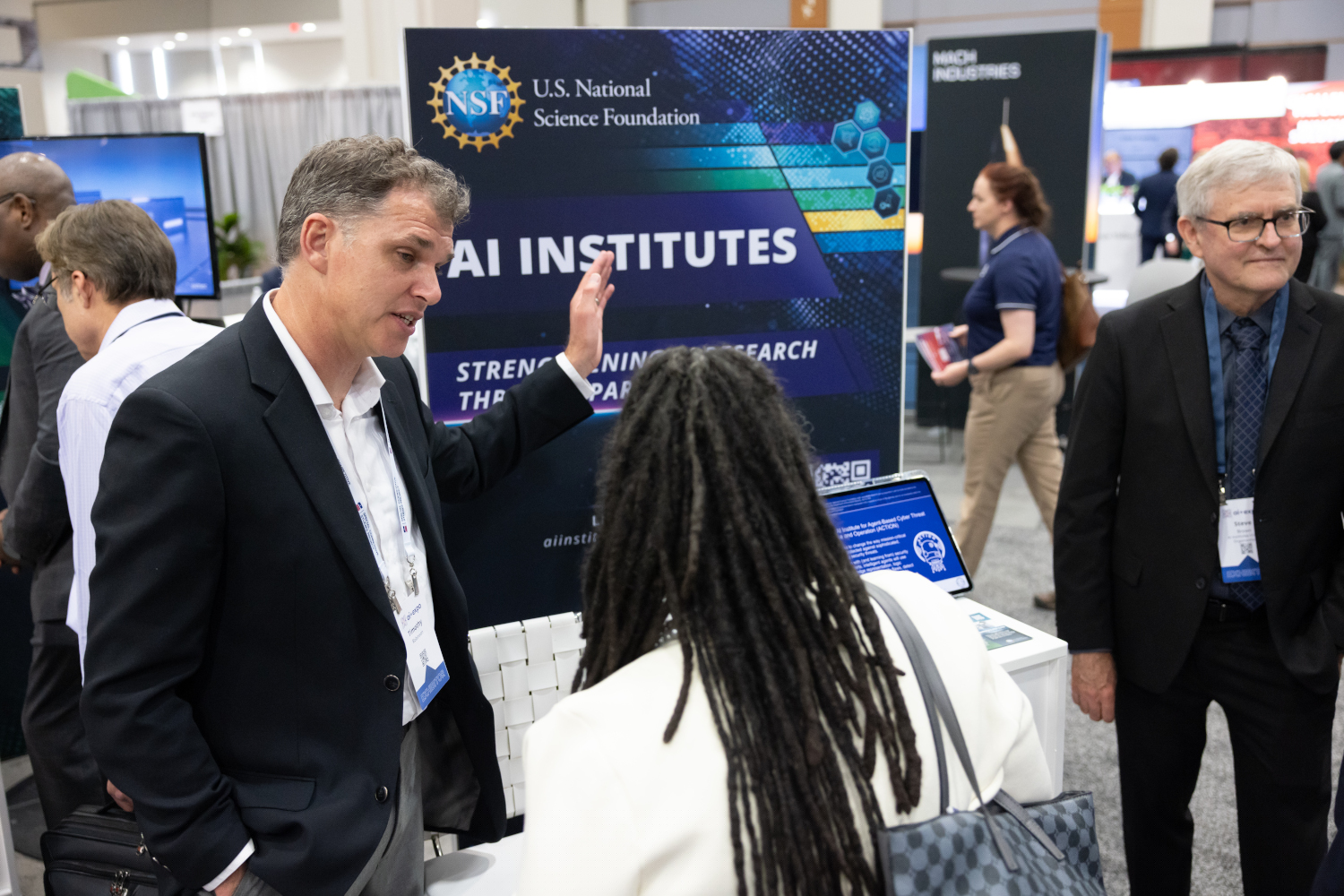 On June 2, 2025, Timothy Robinson spoke about the AI Institutes with visitors to the NSF booth at the AI+ Expo in Washington, D.C. Photo credit: Charlotte Geary/NSF.