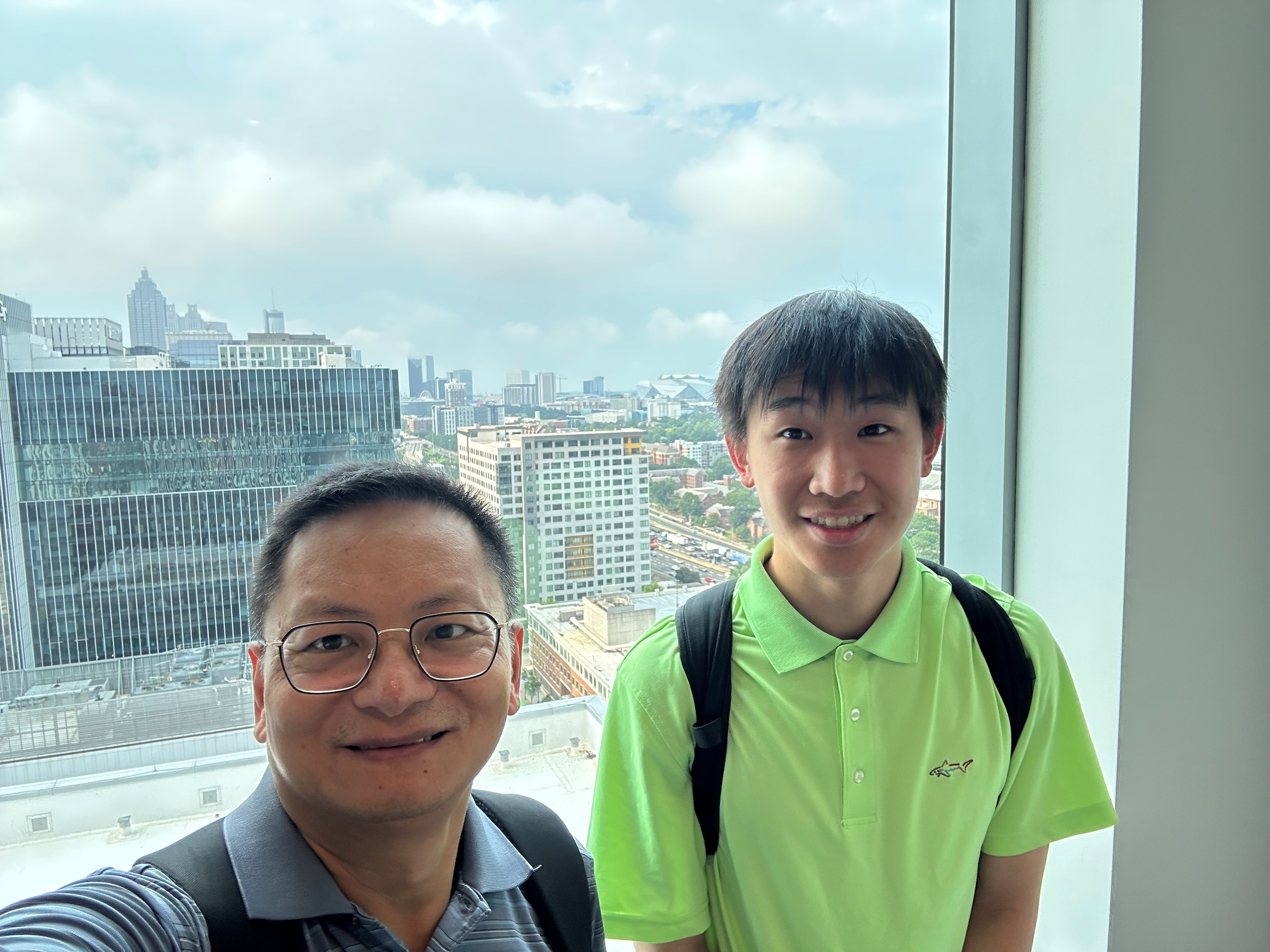 Photo of Professor Xiaoming Huo and intern Bell Chen against Atlanta skyline. 